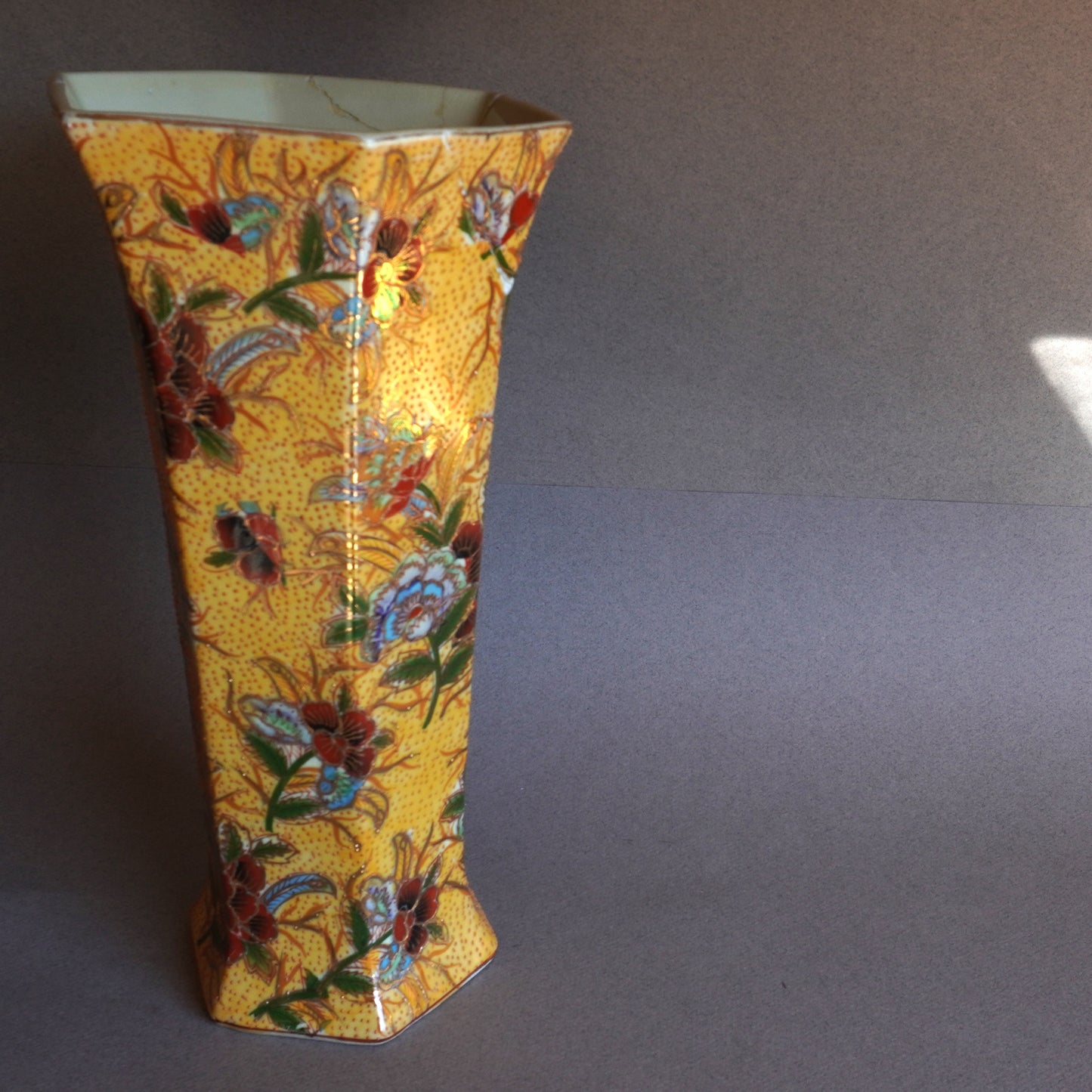 Asian Decorative vase with floral patterns on a plain background