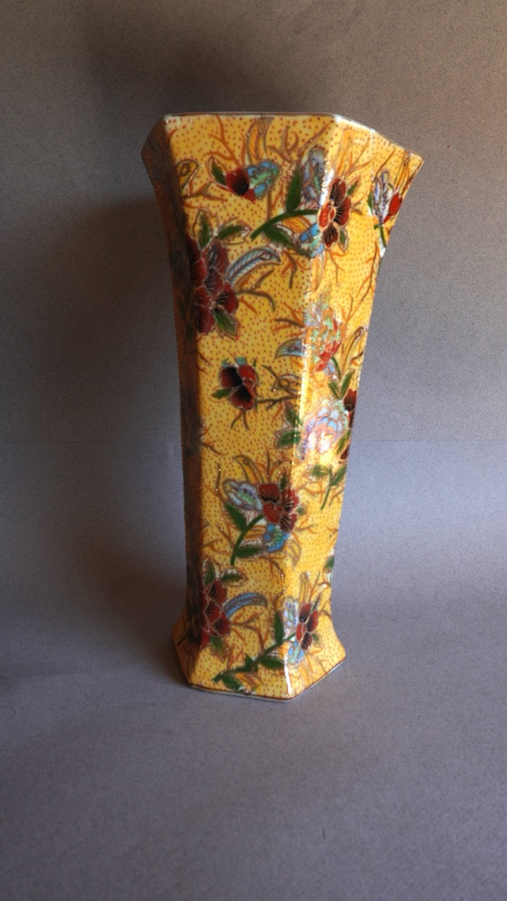 Decorative vase with floral patterns on a plain background