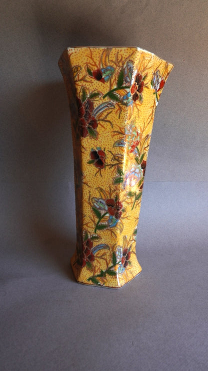 Decorative vase with floral patterns on a plain background