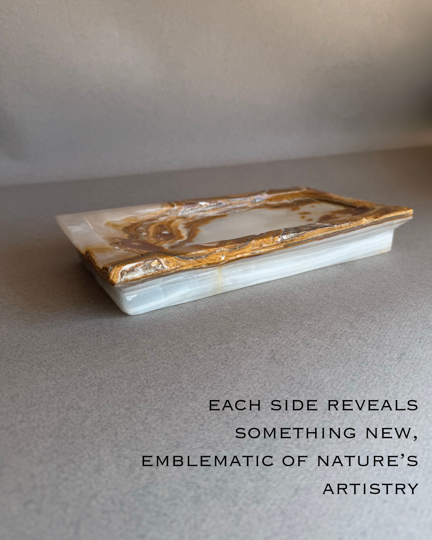 Hand-carved ivory and brown onyx catchall tray with natural translucency and bold veining
