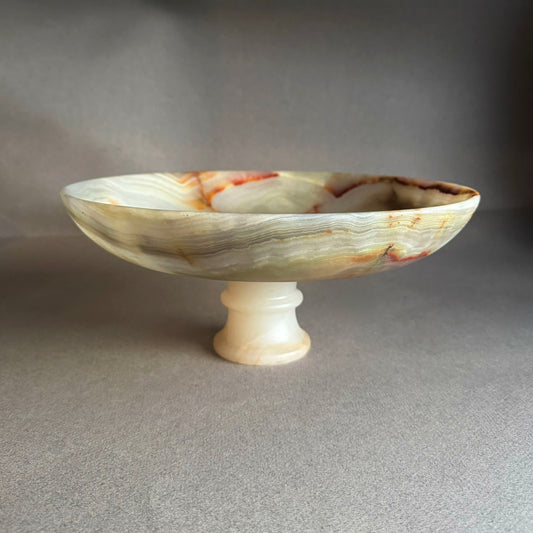 Marble-patterned pedestal bowl on a gray background