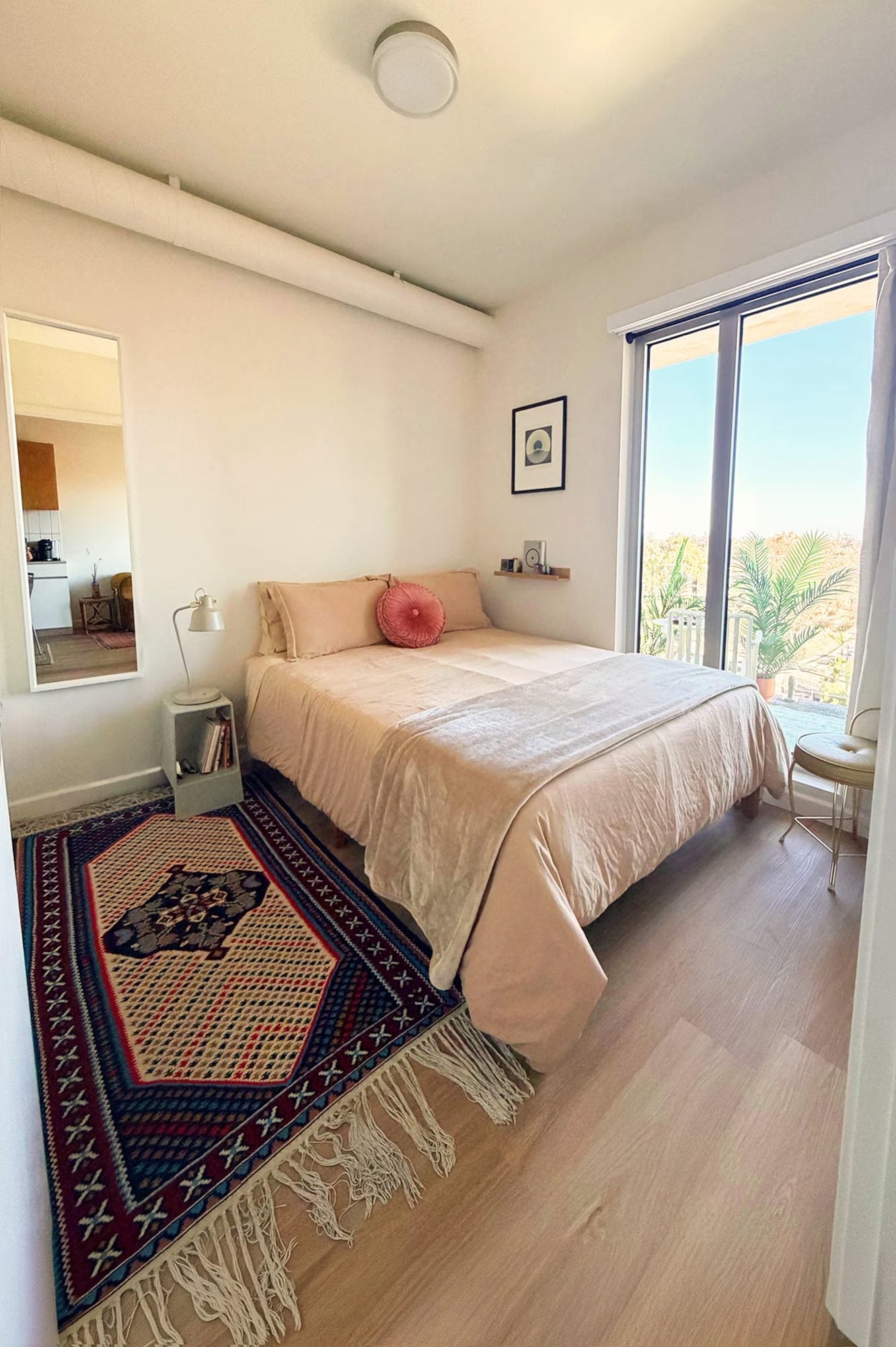 Bedroom opening to a balcony